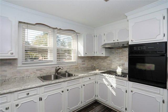 kitchen with white cabinets, decorative backsplash, sink, and black appliances