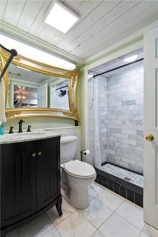 bathroom featuring toilet, vanity, marble finish floor, ornamental molding, and a stall shower