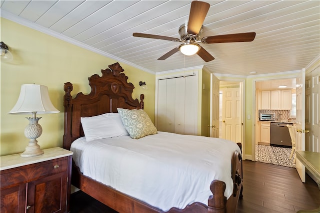 bedroom featuring dark wood-style floors, ornamental molding, and a closet