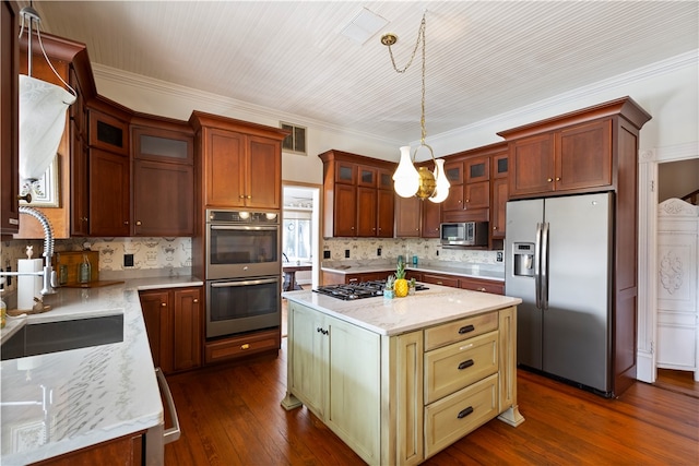 kitchen featuring light stone counters, stainless steel appliances, a sink, decorative backsplash, and dark wood-style floors