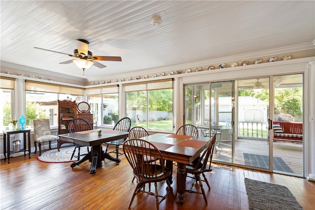 dining room with hardwood / wood-style floors, plenty of natural light, and crown molding