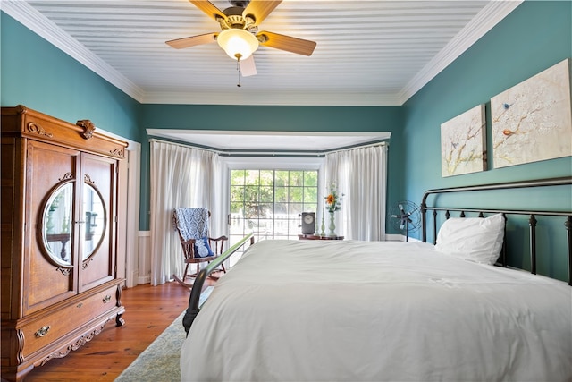 bedroom with a ceiling fan, ornamental molding, and wood finished floors