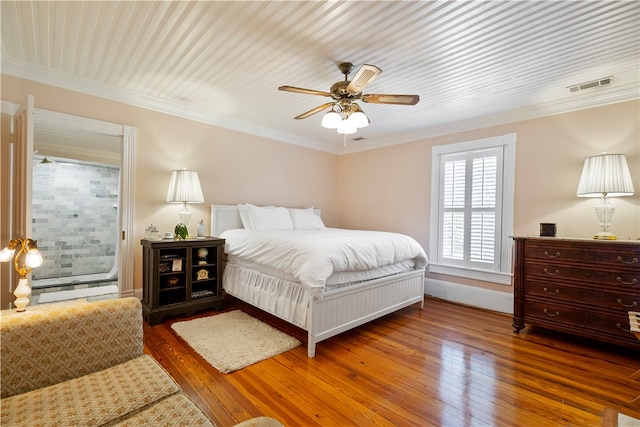 bedroom featuring a ceiling fan, visible vents, crown molding, and hardwood / wood-style floors