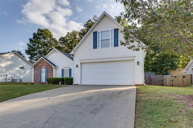 view of property featuring a front lawn and a garage