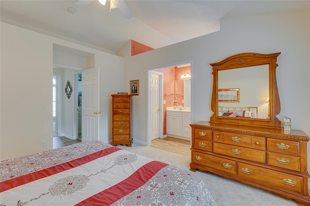 carpeted bedroom with ceiling fan and connected bathroom