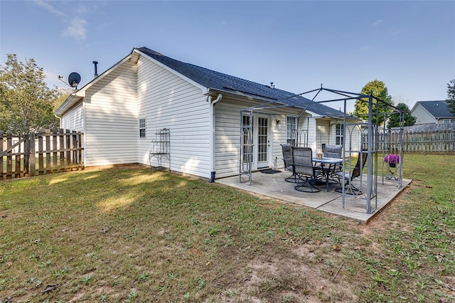 rear view of property with a yard and a patio area