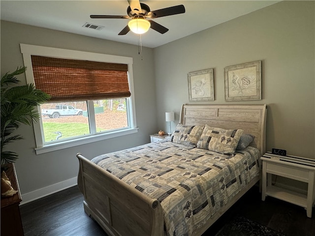 bedroom with ceiling fan and dark hardwood / wood-style flooring