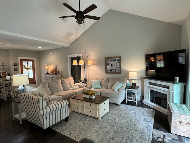 living room with a fireplace, ceiling fan, dark hardwood / wood-style flooring, and high vaulted ceiling