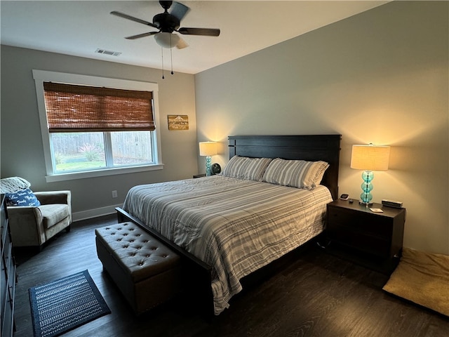 bedroom with ceiling fan and dark hardwood / wood-style flooring