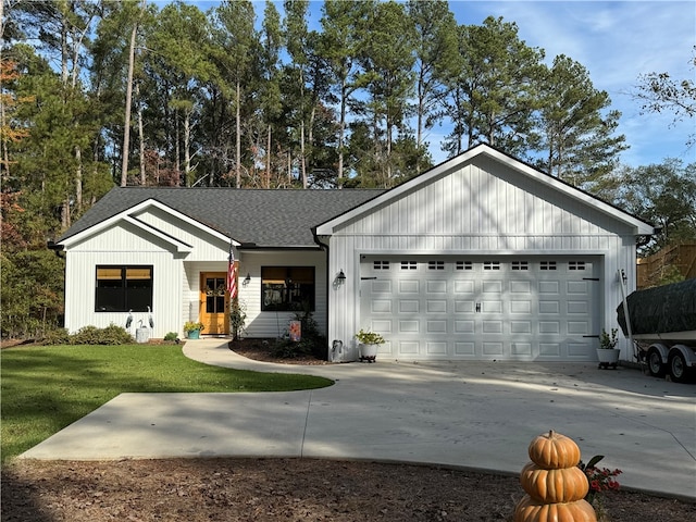 view of front of property with a front yard and a garage