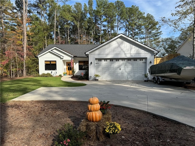 modern inspired farmhouse featuring a front yard and a garage