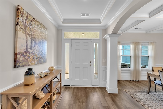 foyer with ornamental molding, coffered ceiling, decorative columns, and hardwood / wood-style flooring