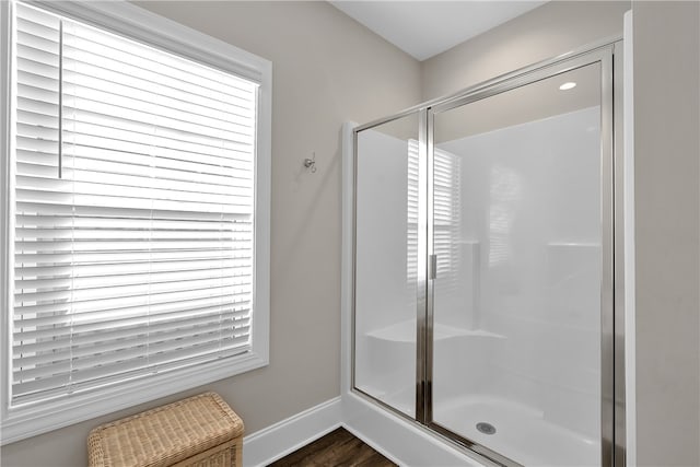 bathroom featuring walk in shower and wood-type flooring