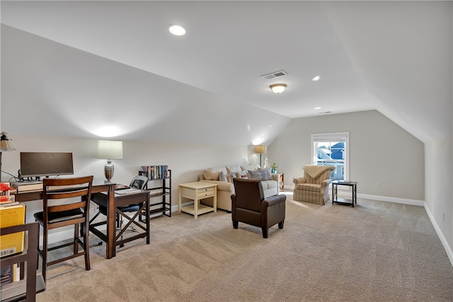 carpeted office space with vaulted ceiling