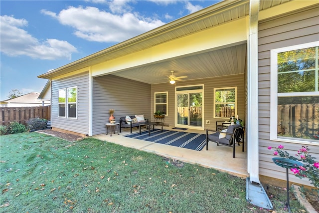 back of house with an outdoor hangout area, ceiling fan, a lawn, and a patio area