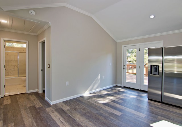 unfurnished dining area with vaulted ceiling, ornamental molding, and dark hardwood / wood-style flooring