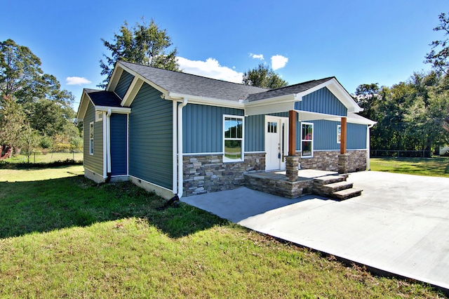 view of front facade with a patio and a front yard