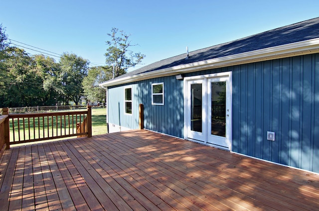 wooden terrace with french doors and a yard