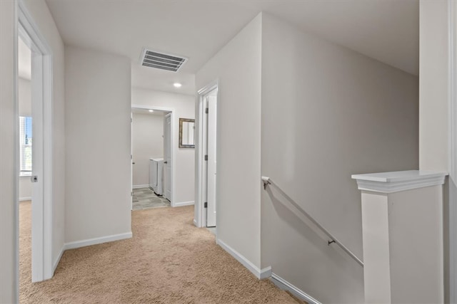 hallway with light colored carpet