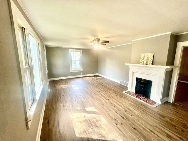 unfurnished living room with ornamental molding, hardwood / wood-style flooring, and ceiling fan