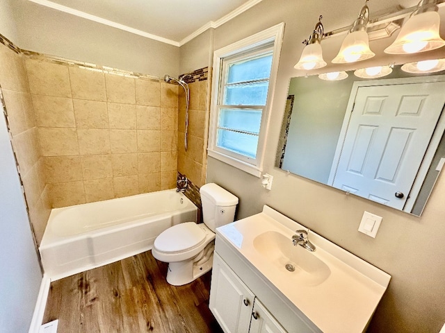 full bathroom featuring toilet, crown molding, tiled shower / bath, and hardwood / wood-style floors