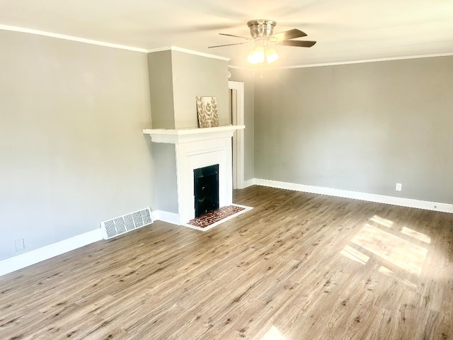 unfurnished living room featuring crown molding, light hardwood / wood-style floors, and ceiling fan