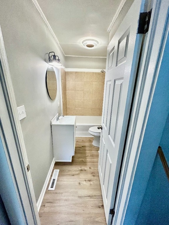 bathroom featuring hardwood / wood-style flooring, toilet, crown molding, vanity, and a textured ceiling