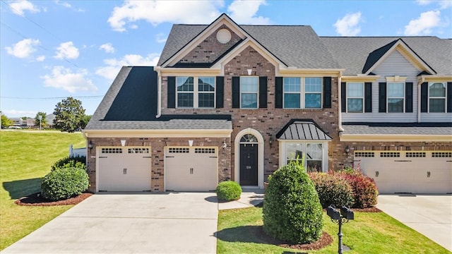 view of front of house featuring a garage and a front lawn