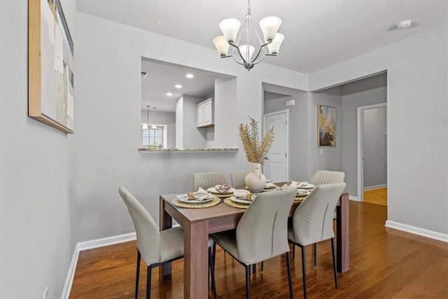 dining space with a chandelier and wood-type flooring