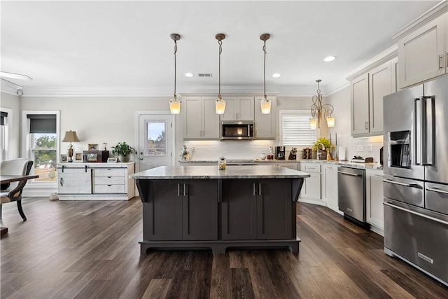 kitchen with decorative backsplash, stainless steel appliances, and a wealth of natural light