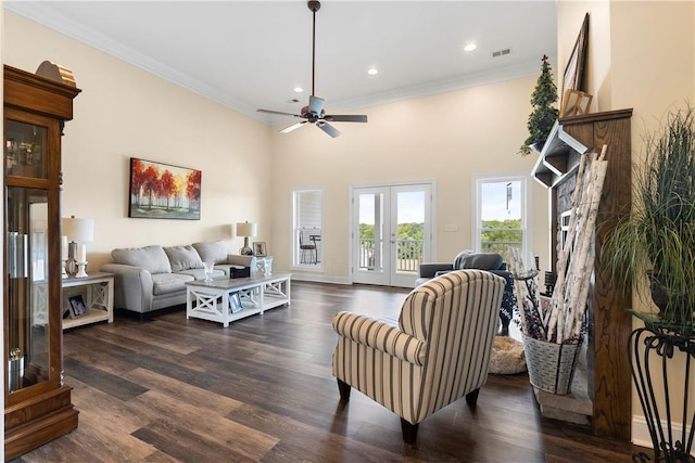 living room with crown molding, ceiling fan, dark wood-type flooring, visible vents, and recessed lighting