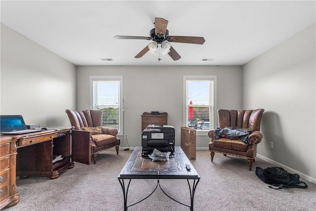 sitting room with plenty of natural light, visible vents, ceiling fan, and light carpet