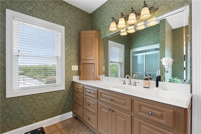 bathroom with wallpapered walls, vanity, a chandelier, baseboards, and tile patterned flooring