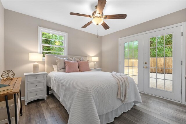 bedroom with access to outside, multiple windows, and wood-type flooring