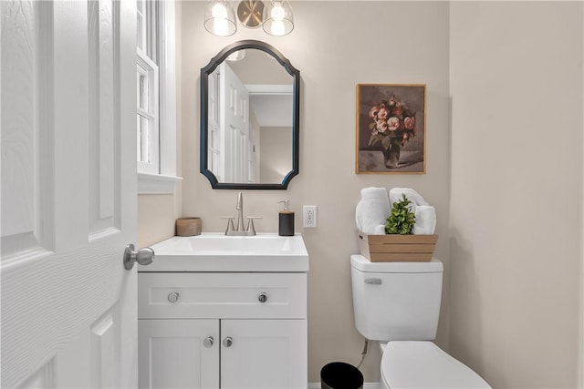 half bath featuring toilet and vanity