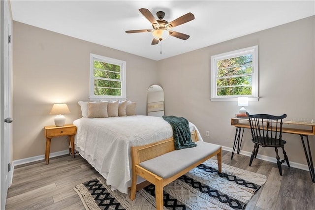 bedroom with light wood-type flooring and ceiling fan