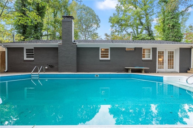 view of swimming pool featuring french doors