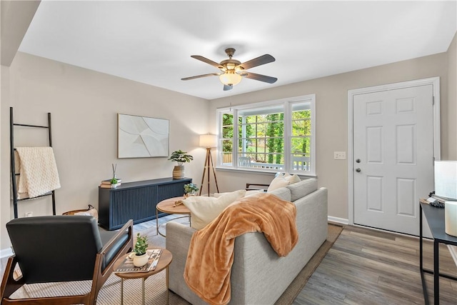 living room featuring wood-type flooring and ceiling fan