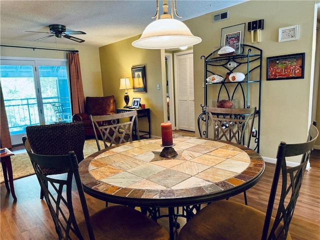 811 Northlake Dr, Anderson, SC 29625 - dining room featuring wood finished floors, ceiling fan, a textured ceiling, and baseboards