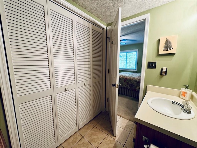 811 Northlake Dr, Anderson, SC 29625 - bathroom with a textured ceiling, vanity, a closet, tile patterned flooring, and connected bathroom