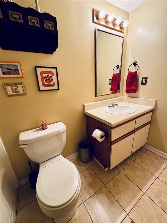 811 Northlake Dr, Anderson, SC 29625 - bathroom featuring vanity, toilet, baseboards, and tile patterned flooring