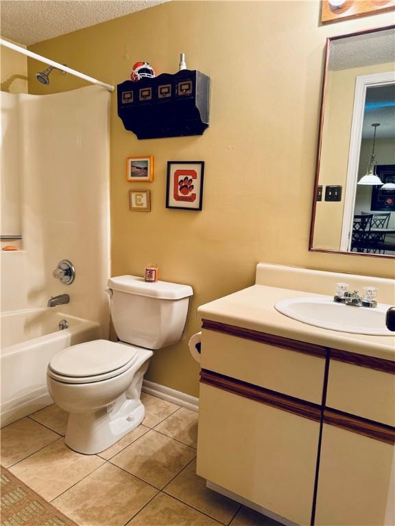 811 Northlake Dr, Anderson, SC 29625 - full bath with vanity, toilet, tile patterned flooring,  shower combination, and a textured ceiling