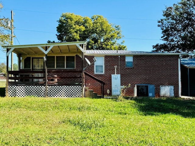 back of property featuring a yard, a deck, and cooling unit