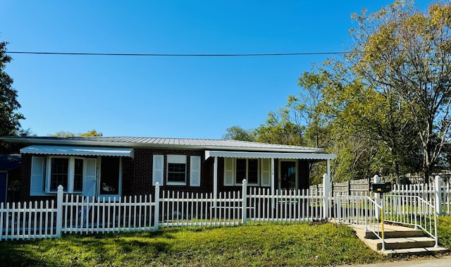 ranch-style house with covered porch and a front lawn