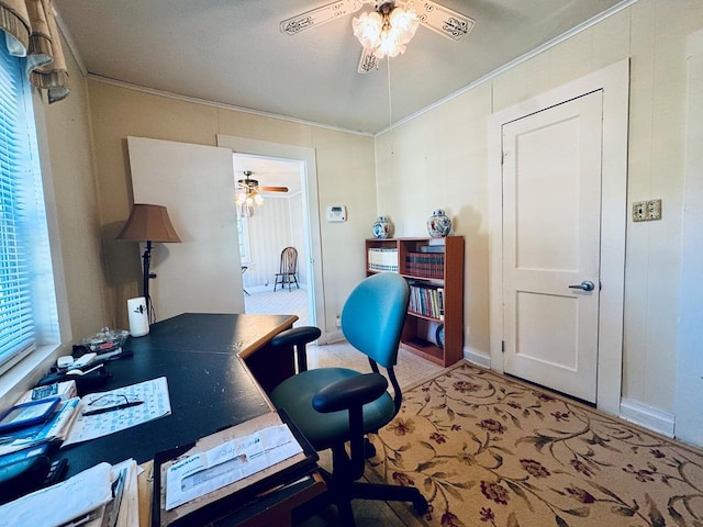 carpeted office space featuring ornamental molding and ceiling fan