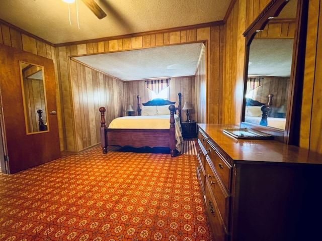 bedroom with ceiling fan, wood walls, a textured ceiling, and ornamental molding