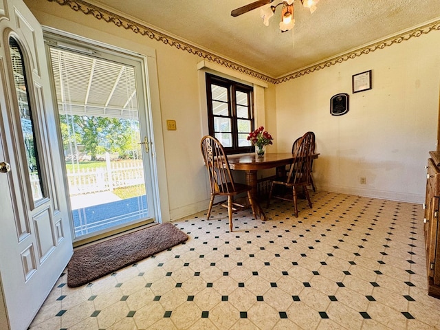 dining space with a textured ceiling and ceiling fan