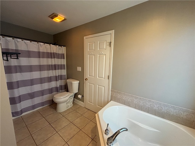 bathroom featuring toilet, a tub to relax in, and tile patterned floors