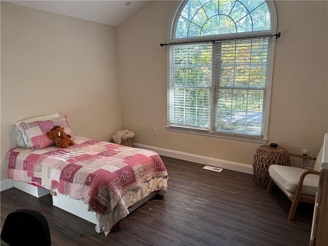 bedroom with dark wood-type flooring and vaulted ceiling