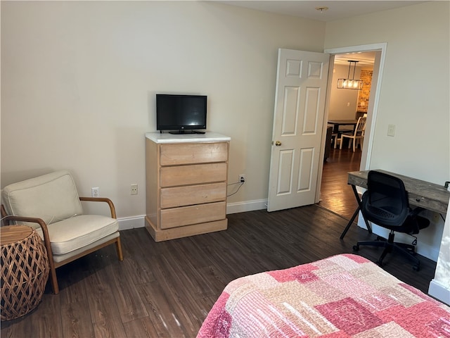 bedroom with dark hardwood / wood-style flooring